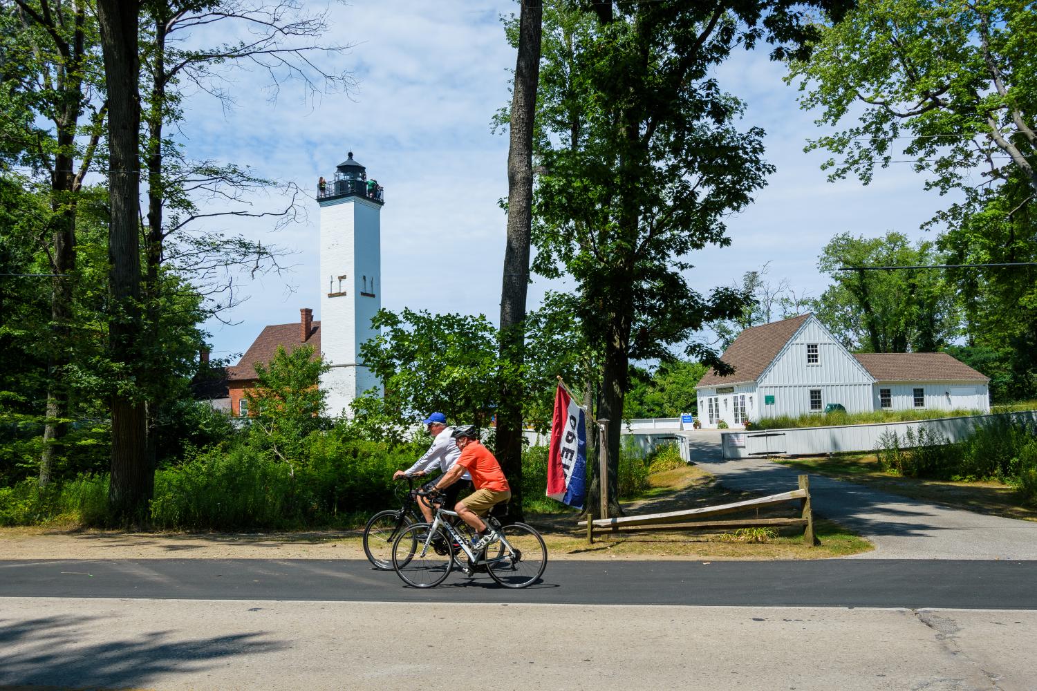 Bikers pass the lighthouse on Presque Isle 