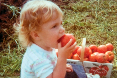 baby eating tomatoes